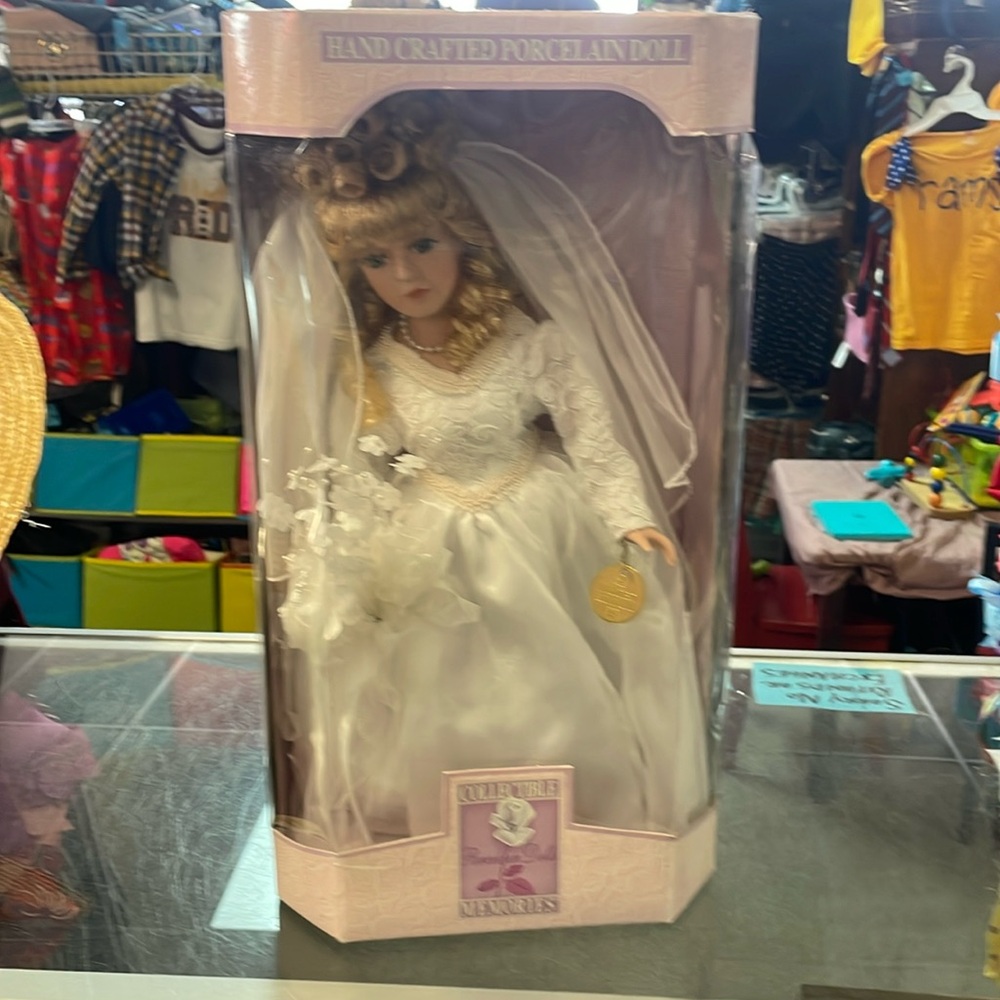 Handcrafted porcelain doll. Some wear on the box